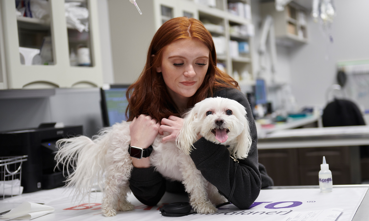 Lady with her dog at the vet